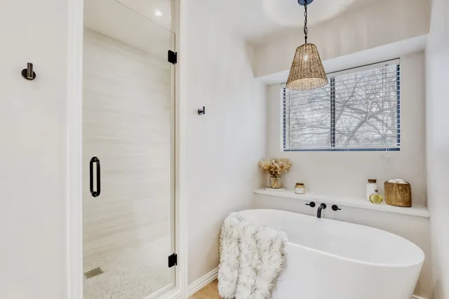 a bathroom with a shower and a bath tub