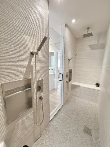 a roof deck with couches and wooden floor