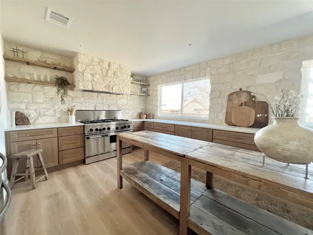 a view of dining table chairs and window