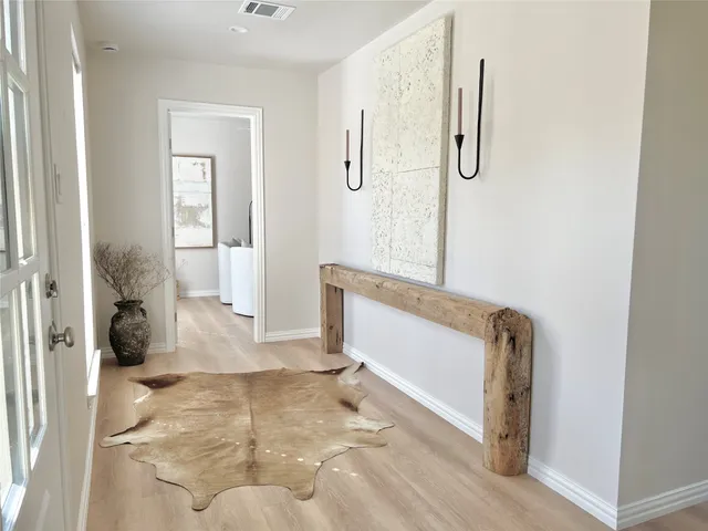 a living room with furniture large window and a fireplace