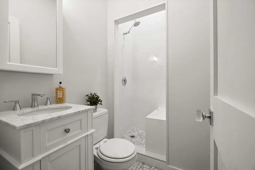 43 Anderson Street, Unit 1 Boston, MA 02114 - Photo 15 of 36 a bathroom with a sink a toilet and shower