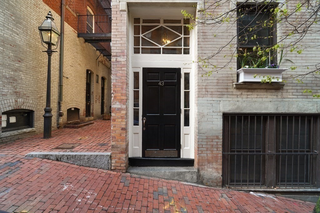 43 Anderson Street, Unit 1 Boston, MA 02114 - Photo 31 of 36 a front view of a house with parking