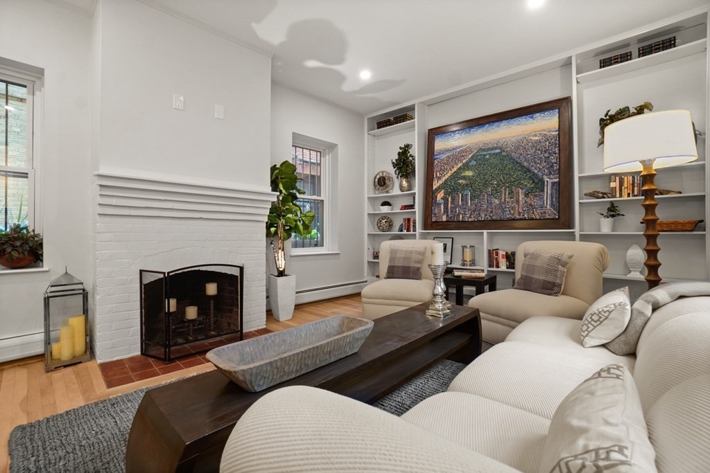 43 Anderson Street, Unit 1 Boston, MA 02114 - Photo 5 of 36 a living room with furniture large window and a fireplace