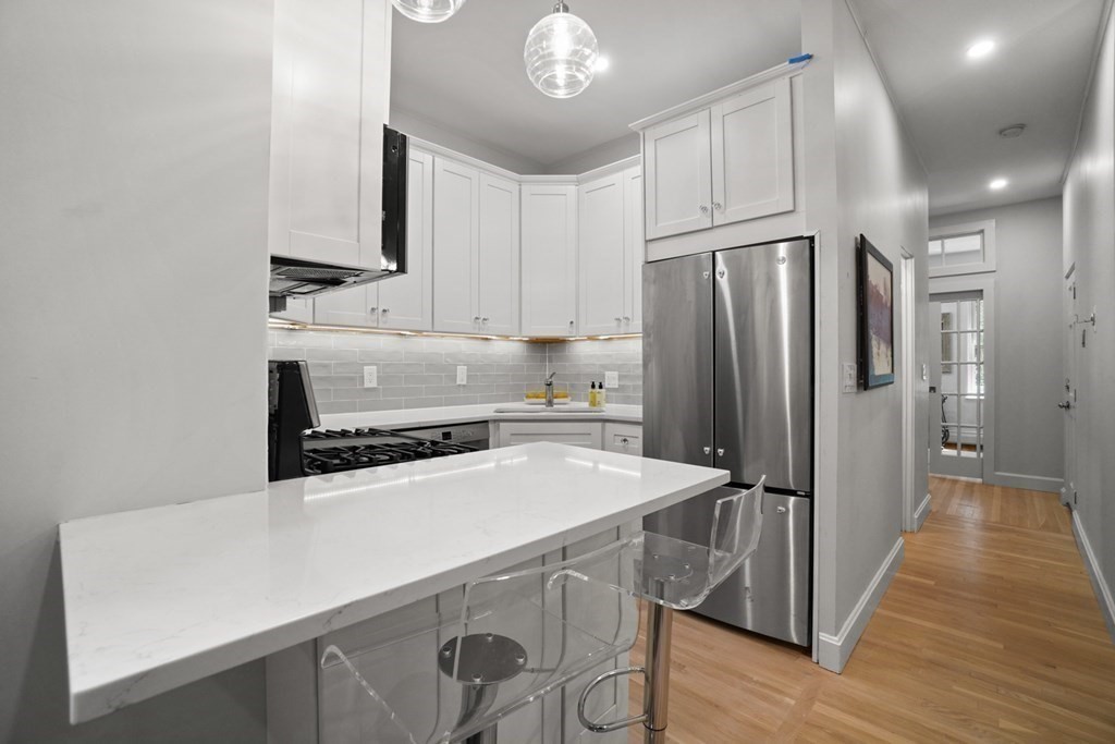 43 Anderson Street, Unit 1 Boston, MA 02114 - Photo 10 of 36 a kitchen with stainless steel appliances a refrigerator and a stove