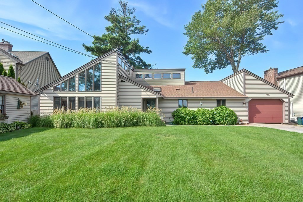 39 Point Pleasant Road Webster, MA 01570 - Photo 3 of 42 a front view of a house with a yard and garage