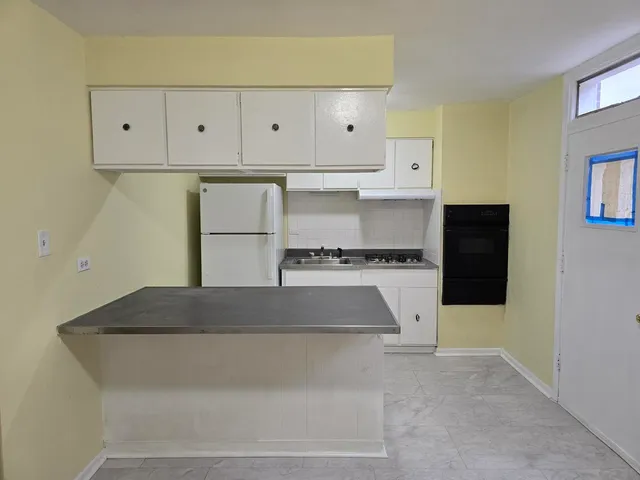 a view of kitchen cabinets and wooden floor