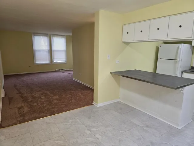 a view of kitchen cabinets and window