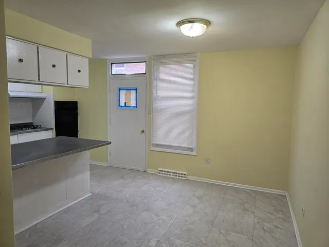 an empty room with cabinet and mirrors