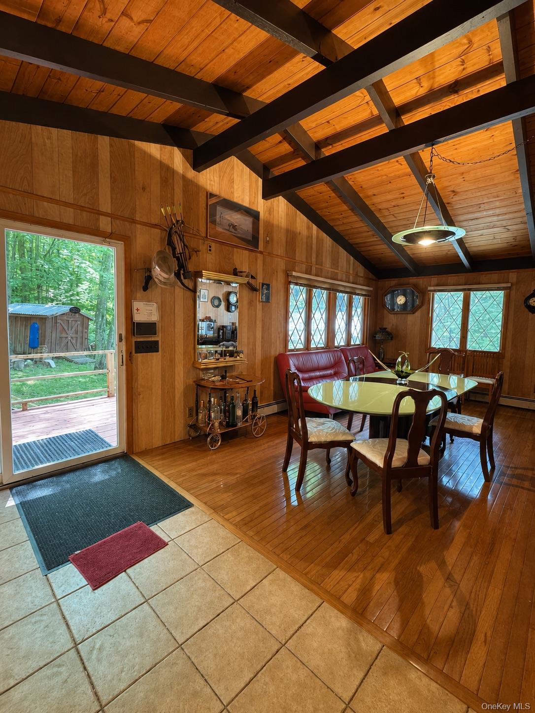 177 Davos Road Woodridge, NY 12789 - Photo 2 of 19 a view of a patio with table and chairs with wooden floor and fence
