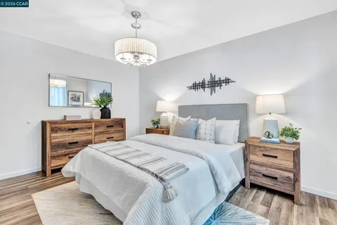a bedroom with bed and wooden floor