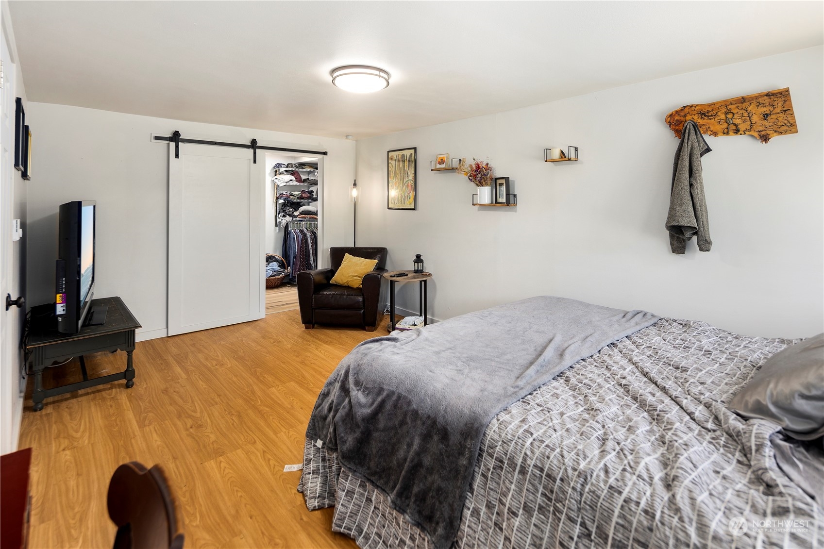 7728 South 128th Street Seattle, WA 98178 - Photo 11 of 31 a bedroom with a bed a couch and a flat screen tv