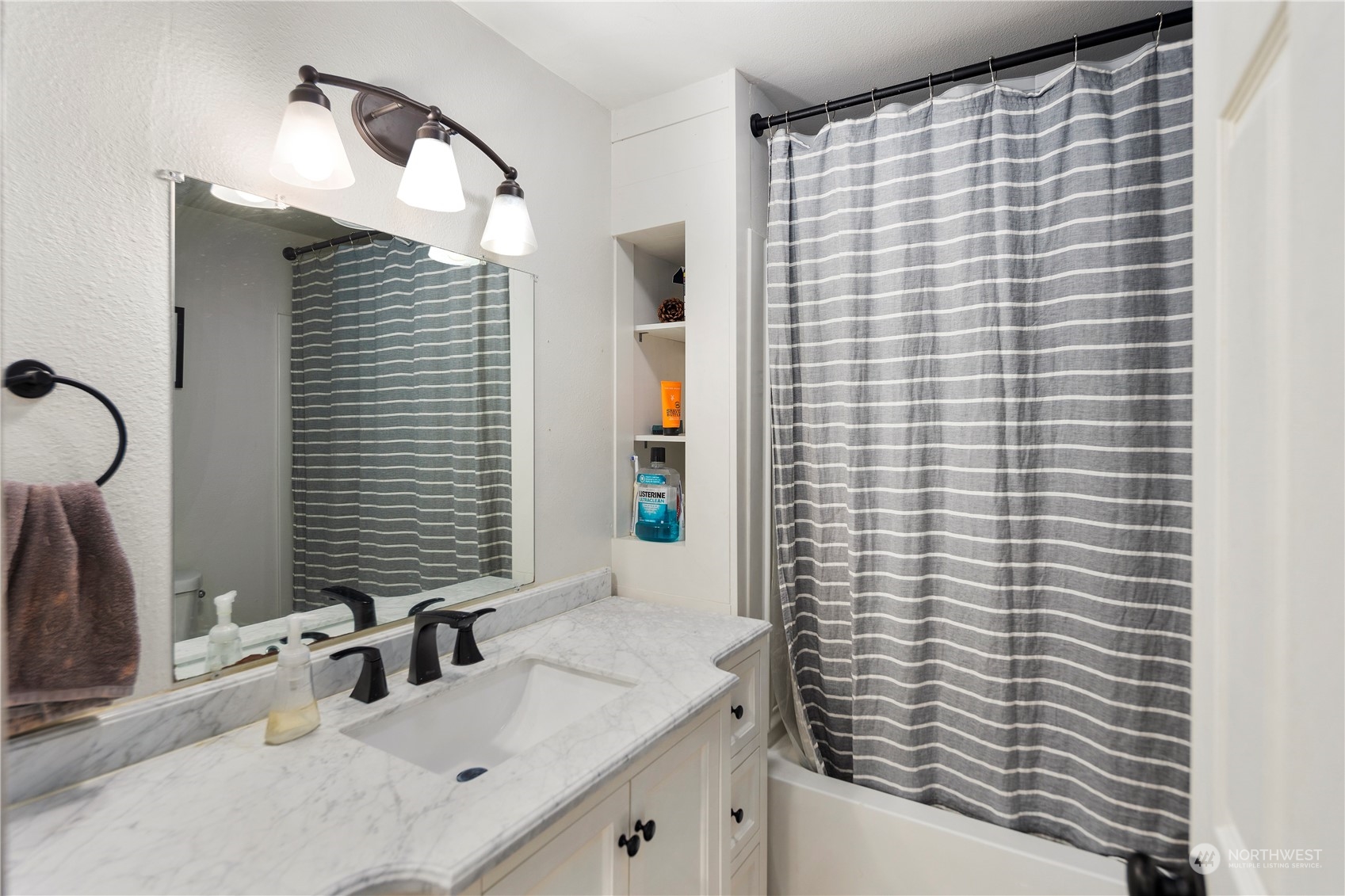 7728 South 128th Street Seattle, WA 98178 - Photo 14 of 31 a bathroom with a sink and a mirror