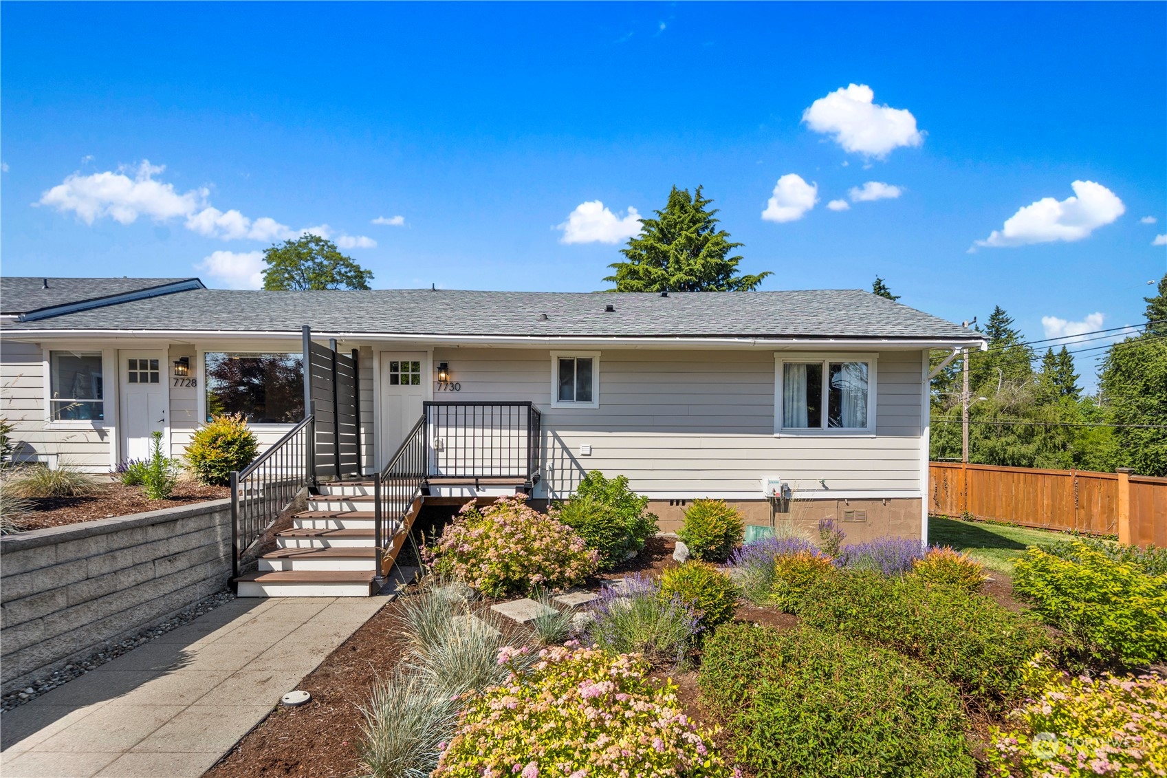 7728 South 128th Street Seattle, WA 98178 - Photo 15 of 31 a front view of house with yard and trees in the background
