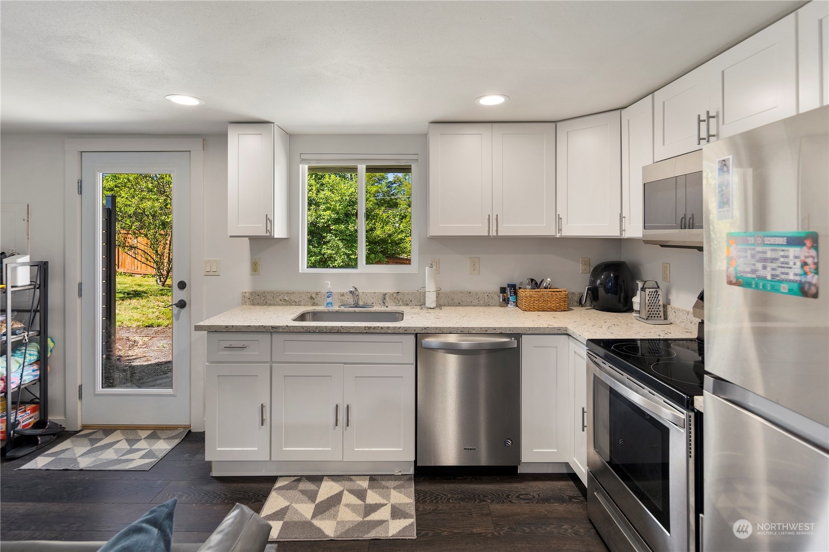 7728 South 128th Street Seattle, WA 98178 - Photo 20 of 31 a kitchen with a sink stove and cabinets