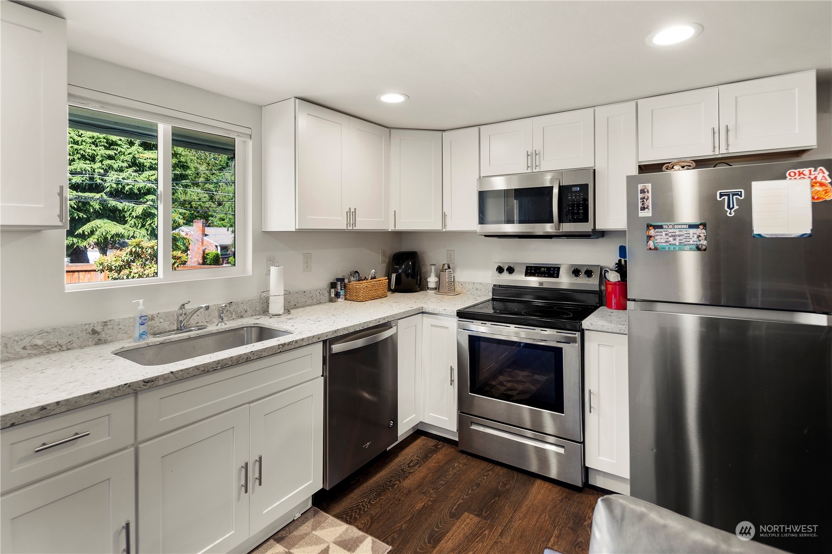 7728 South 128th Street Seattle, WA 98178 - Photo 21 of 31 a kitchen with a sink stove and microwave