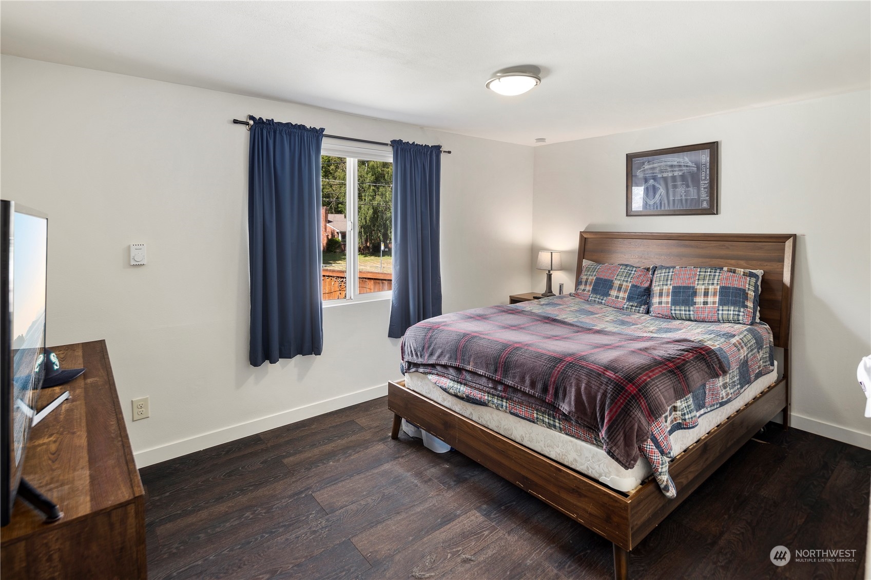 7728 South 128th Street Seattle, WA 98178 - Photo 22 of 31 a spacious bedroom with a bed and wooden floor
