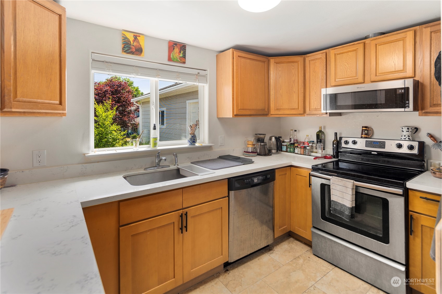7728 South 128th Street Seattle, WA 98178 - Photo 8 of 31 a kitchen with stainless steel appliances granite countertop a sink stove and microwave