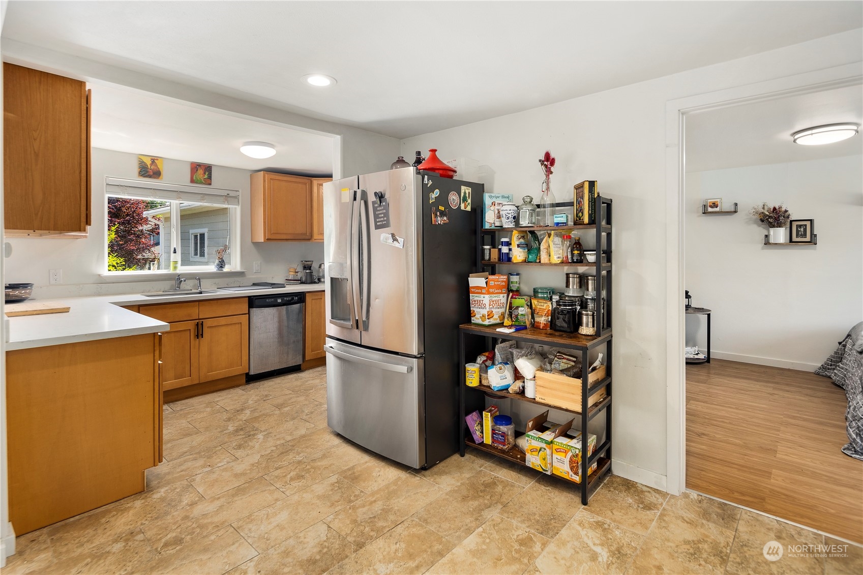 7728 South 128th Street Seattle, WA 98178 - Photo 9 of 31 a kitchen with stainless steel appliances a refrigerator and a sink