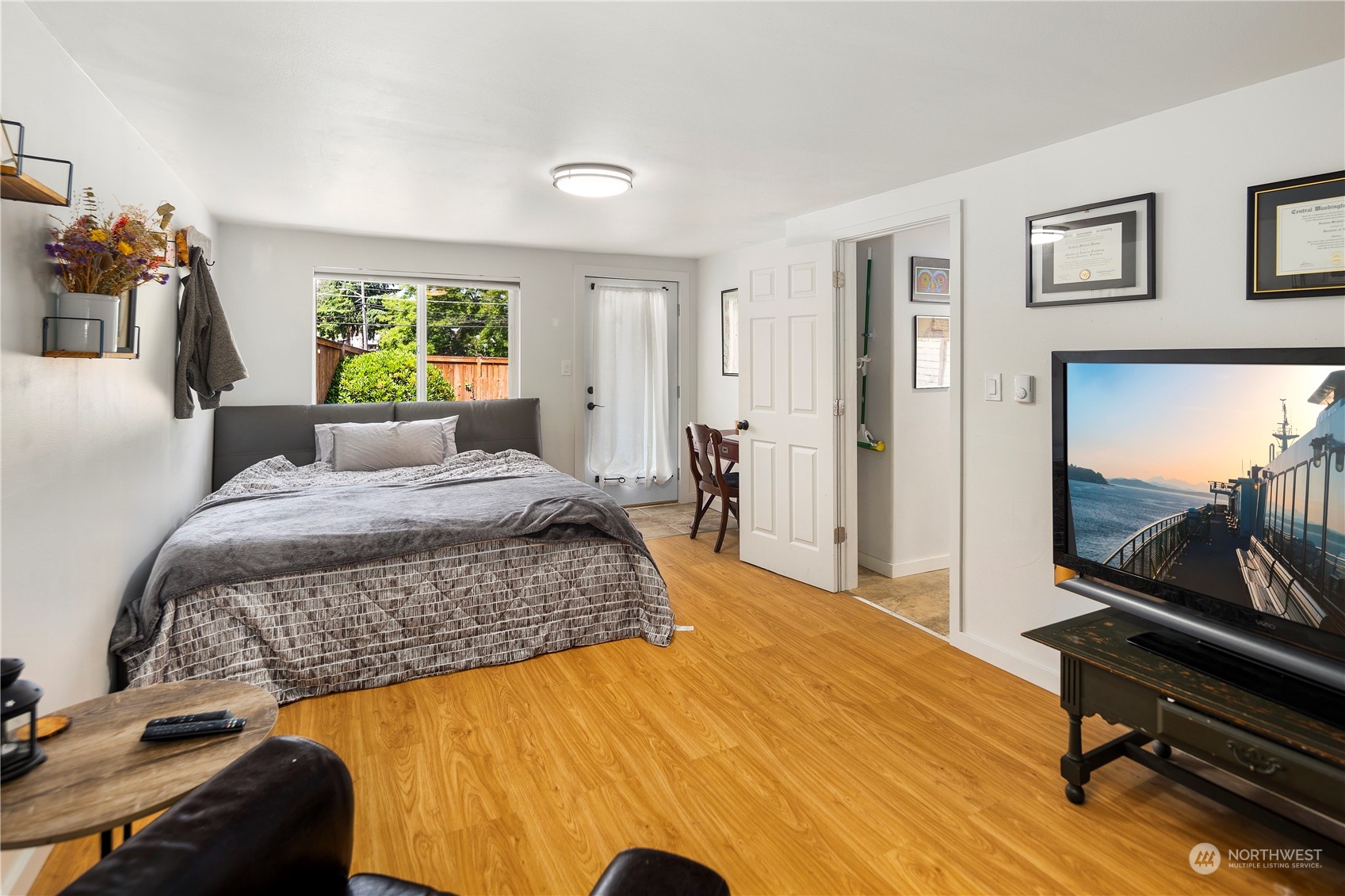 7728 South 128th Street Seattle, WA 98178 - Photo 10 of 31 a bedroom with a bed and a flat tv screen on the dresser