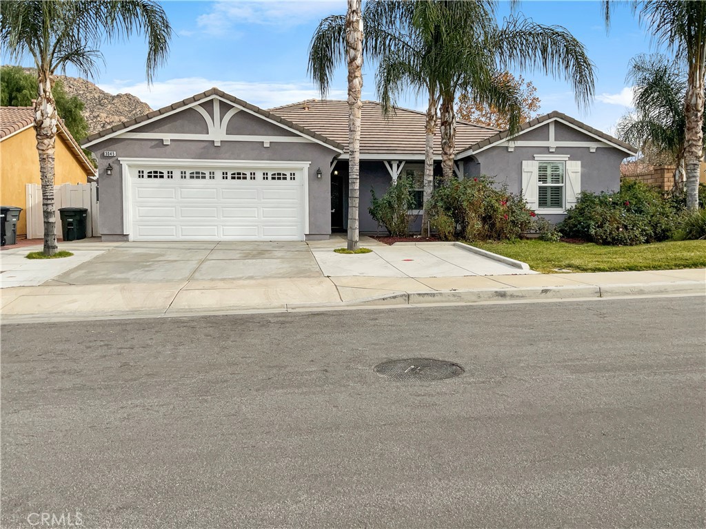 a front view of a house with a garden