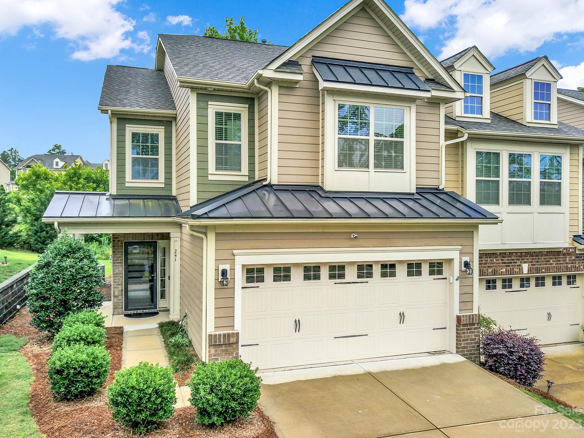 241 Butterfly Place Tega Cay, SC 29708 - Photo 1 of 42 a front view of a house with a garden