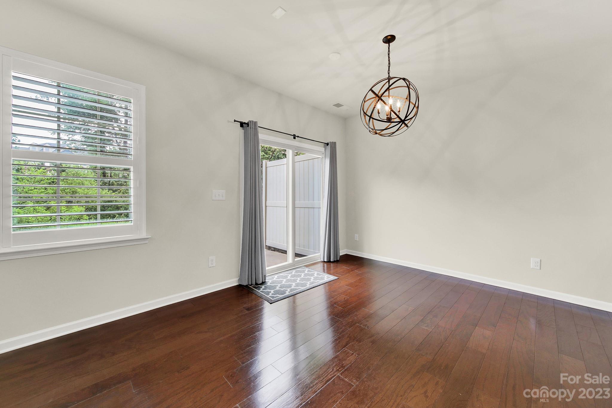 241 Butterfly Place Tega Cay, SC 29708 - Photo 12 of 42 a view of a room with wooden floor exposed radiator and windows
