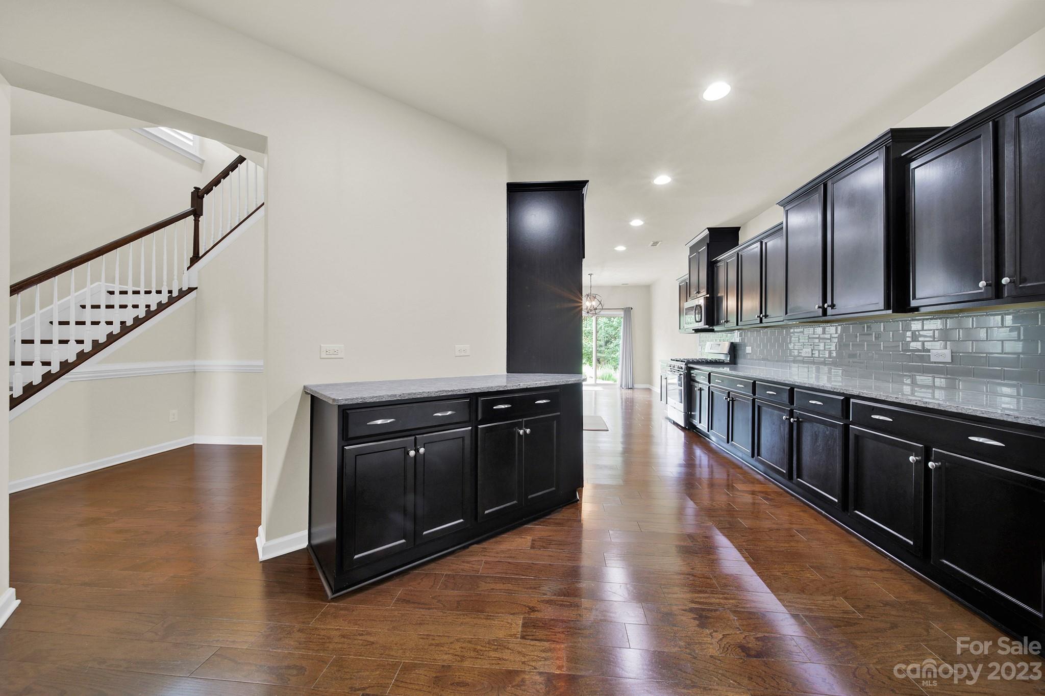 241 Butterfly Place Tega Cay, SC 29708 - Photo 15 of 42 a kitchen with stainless steel appliances granite countertop a stove a sink and a microwave