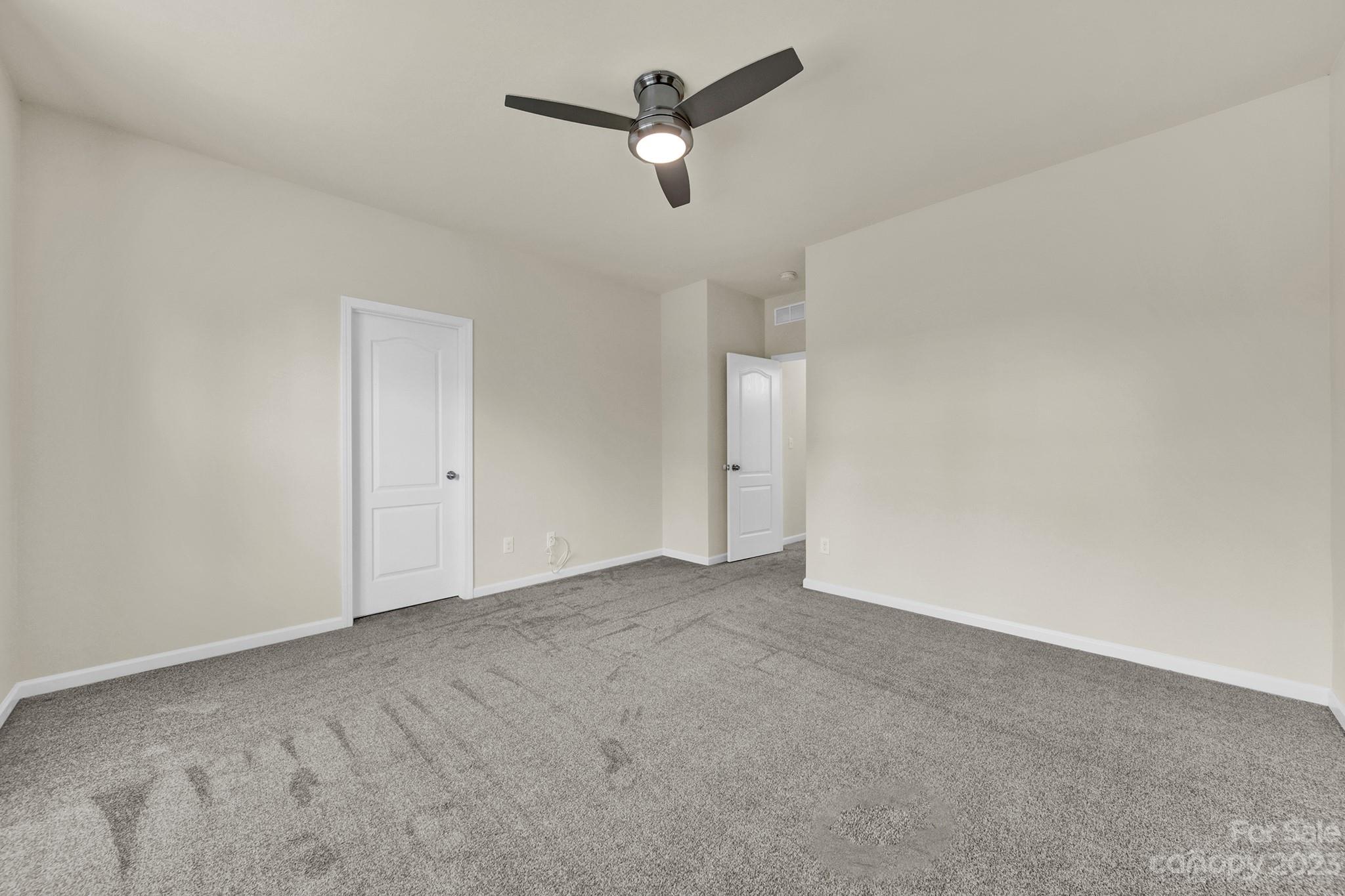 241 Butterfly Place Tega Cay, SC 29708 - Photo 20 of 42 an empty room with ceiling fan and window