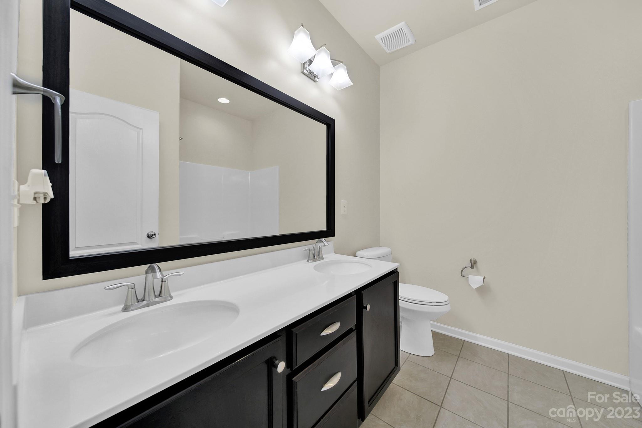 241 Butterfly Place Tega Cay, SC 29708 - Photo 21 of 42 a bathroom with a sink vanity and a mirror
