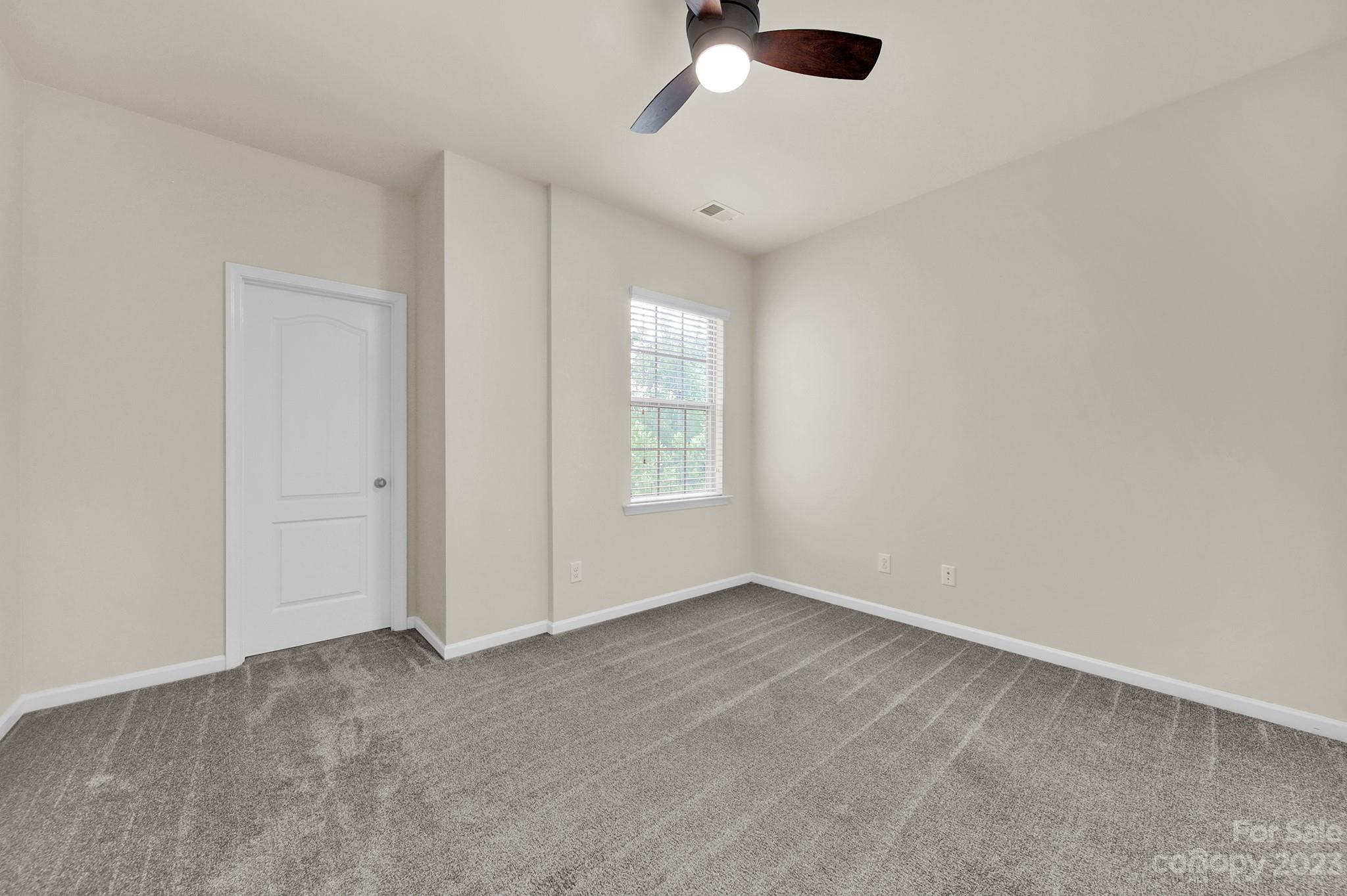 241 Butterfly Place Tega Cay, SC 29708 - Photo 23 of 42 an empty room with a empty space and a ceiling fan