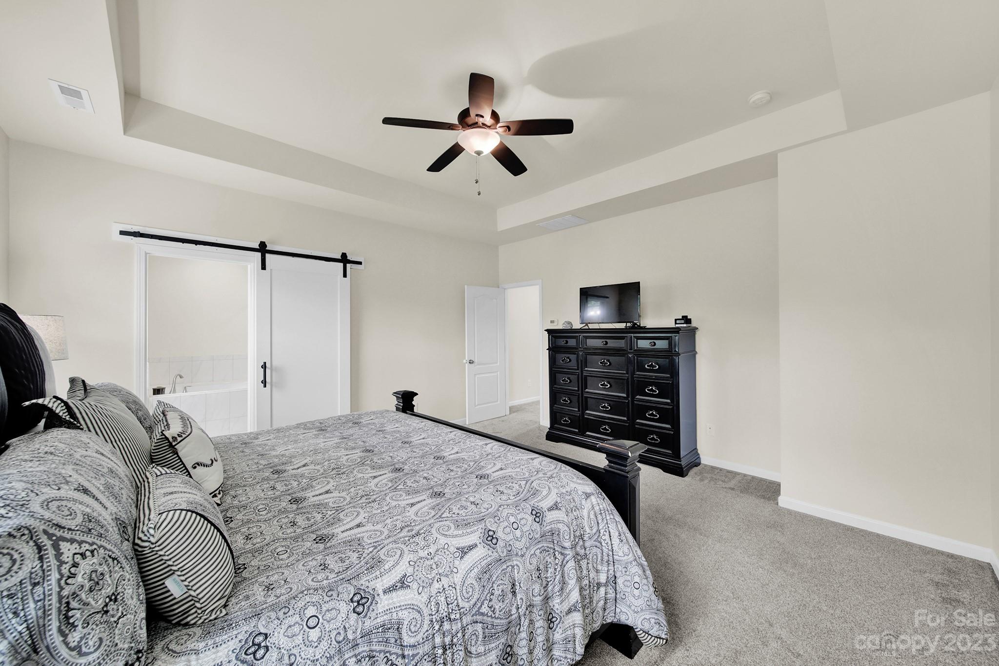 241 Butterfly Place Tega Cay, SC 29708 - Photo 27 of 42 a bedroom with a bed and a television