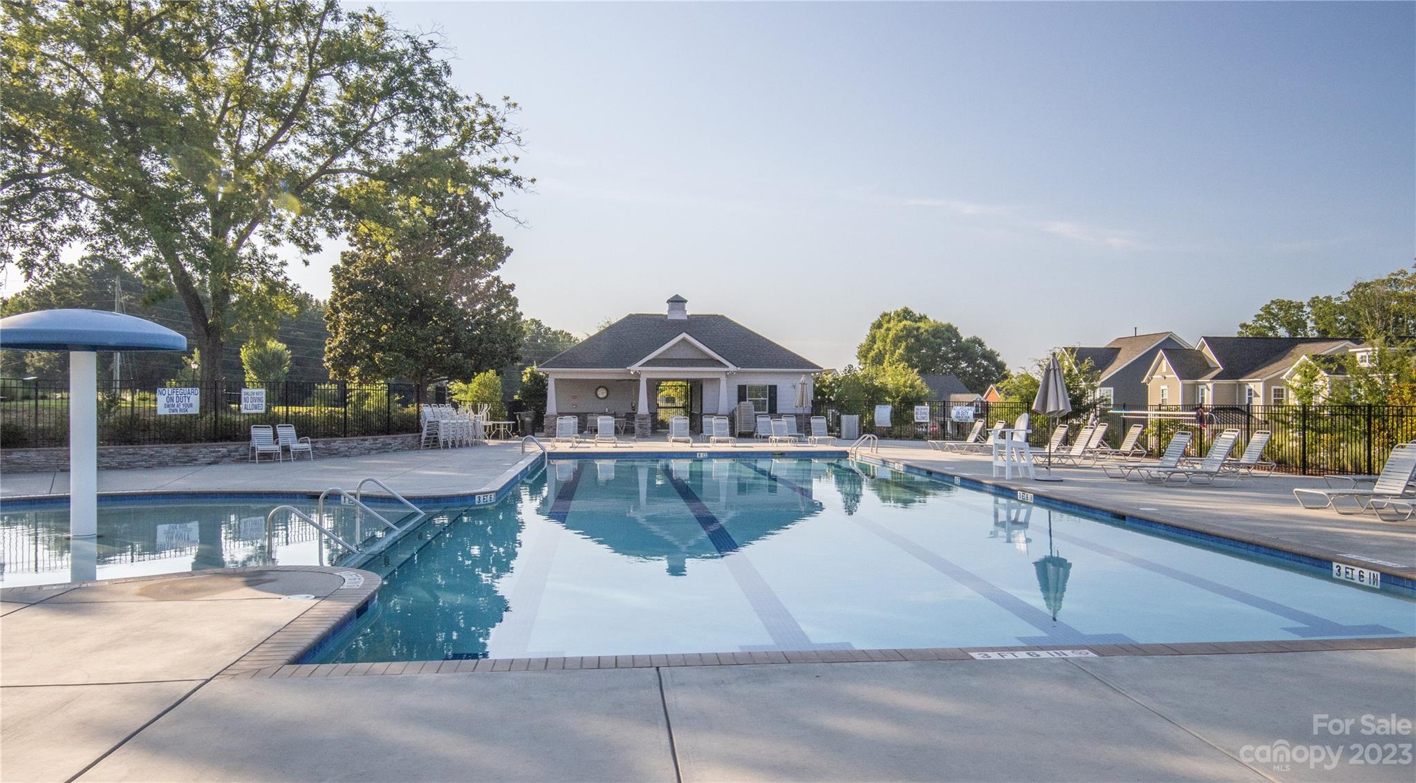 241 Butterfly Place Tega Cay, SC 29708 - Photo 42 of 42 a view of a house with pool and chairs