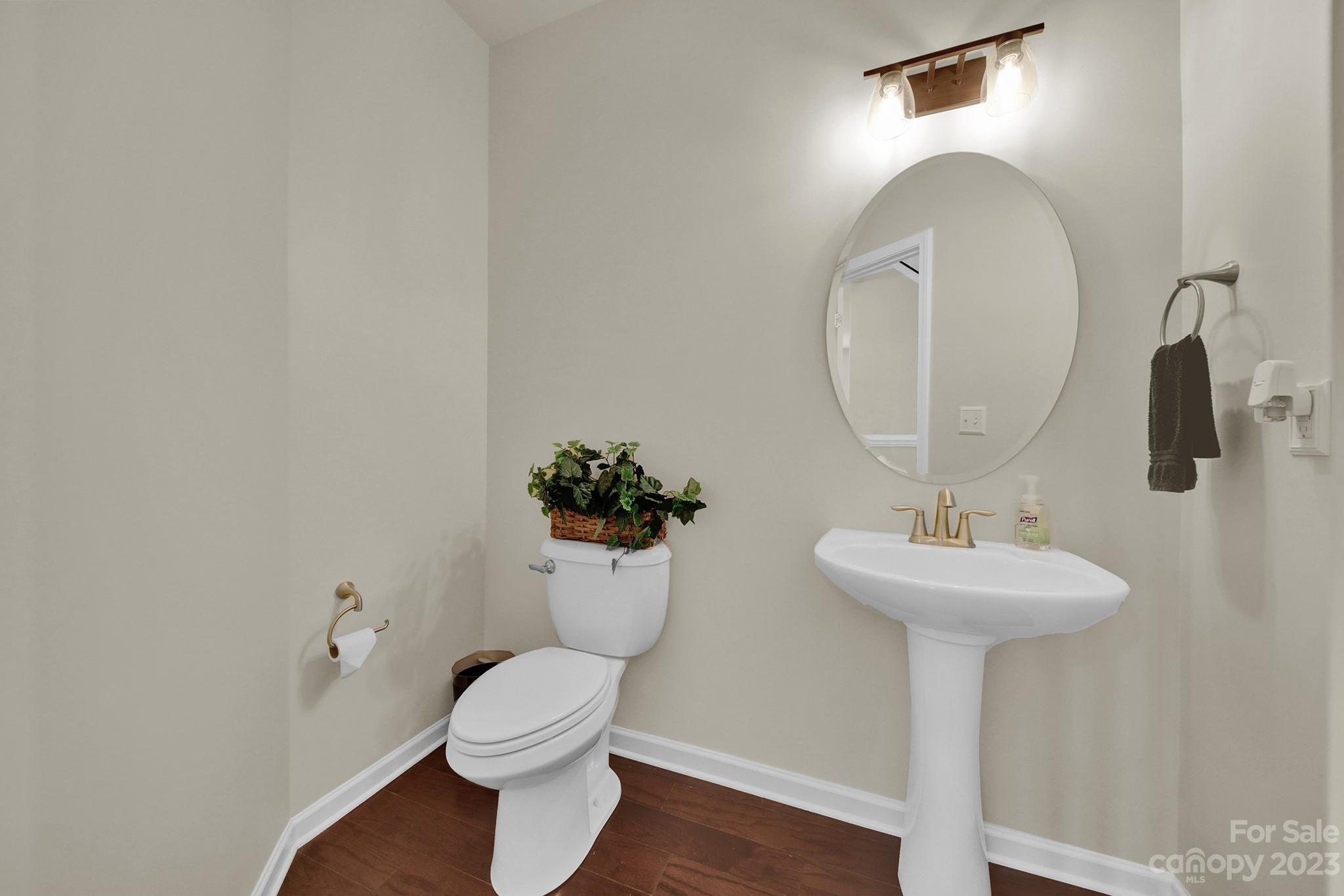 241 Butterfly Place Tega Cay, SC 29708 - Photo 5 of 42 a bathroom with a toilet sink and mirror