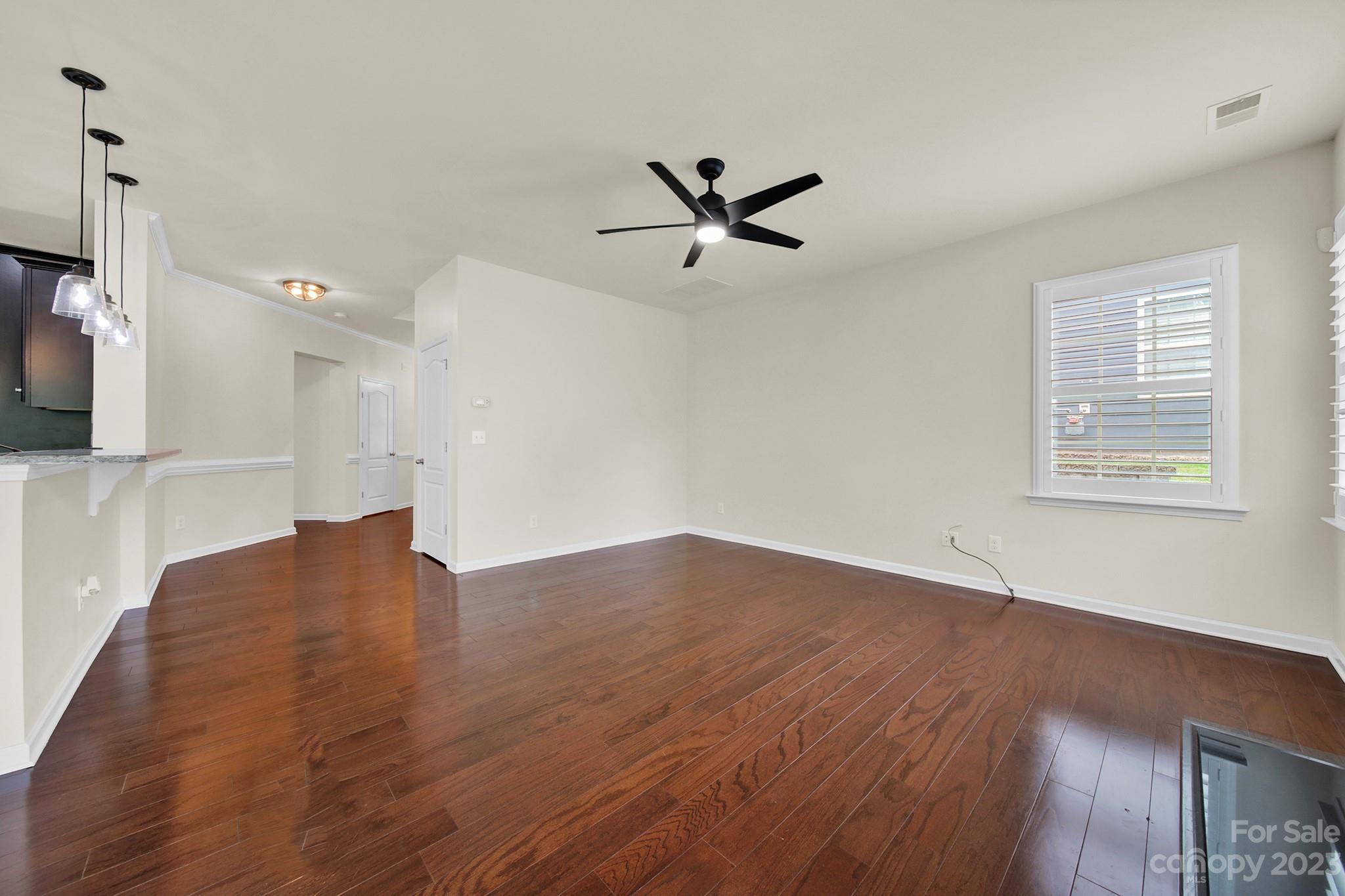 241 Butterfly Place Tega Cay, SC 29708 - Photo 8 of 42 a view of empty room with wooden floor and fan
