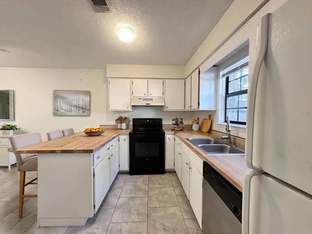 a kitchen with stainless steel appliances granite countertop a sink and cabinets