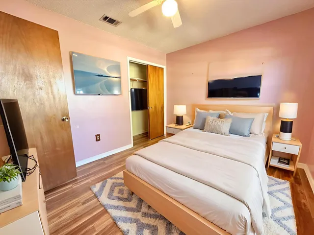 a view of a room with wooden floor and bathroom