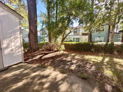 a backyard of a house with a tree