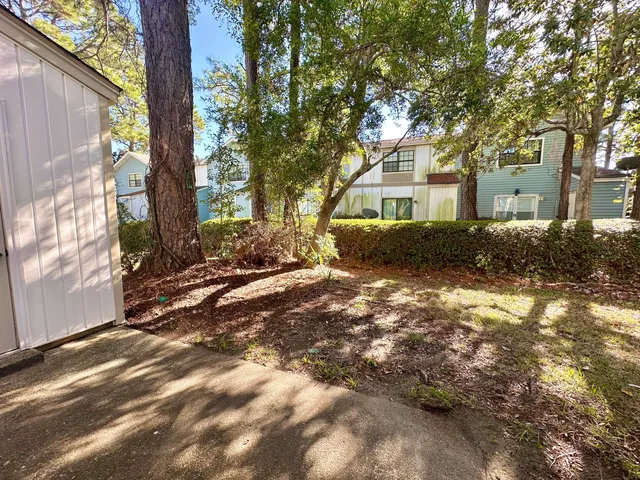 a backyard of a house with a tree