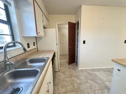 a kitchen with a sink and a refrigerator
