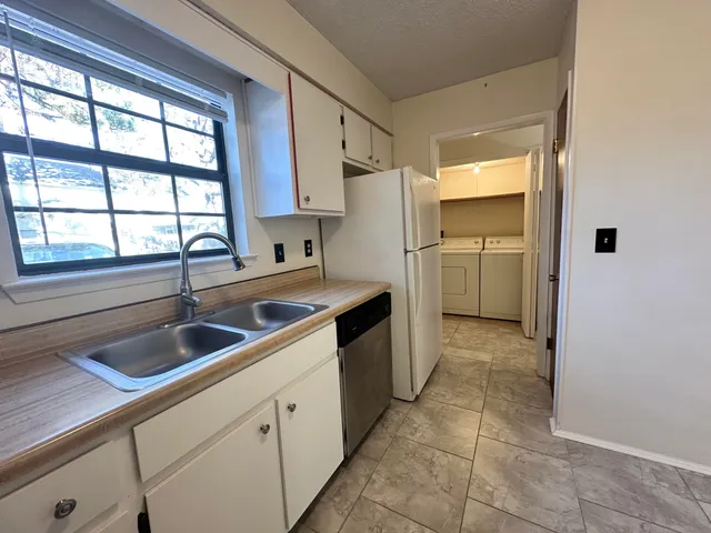 a kitchen with a sink and a refrigerator
