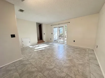 a view of an empty room with windows