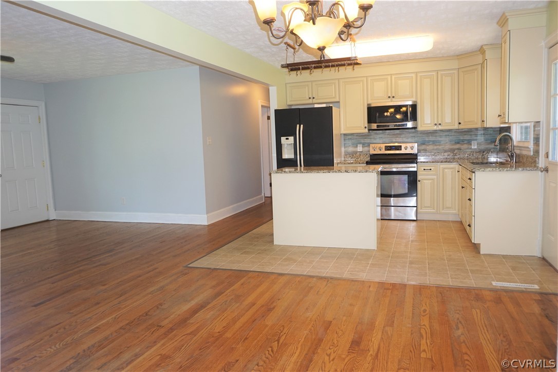 17322 Old Ridge Road Montpelier, VA 23192 - Photo 7 of 50 a kitchen with stainless steel appliances a refrigerator and a stove top oven