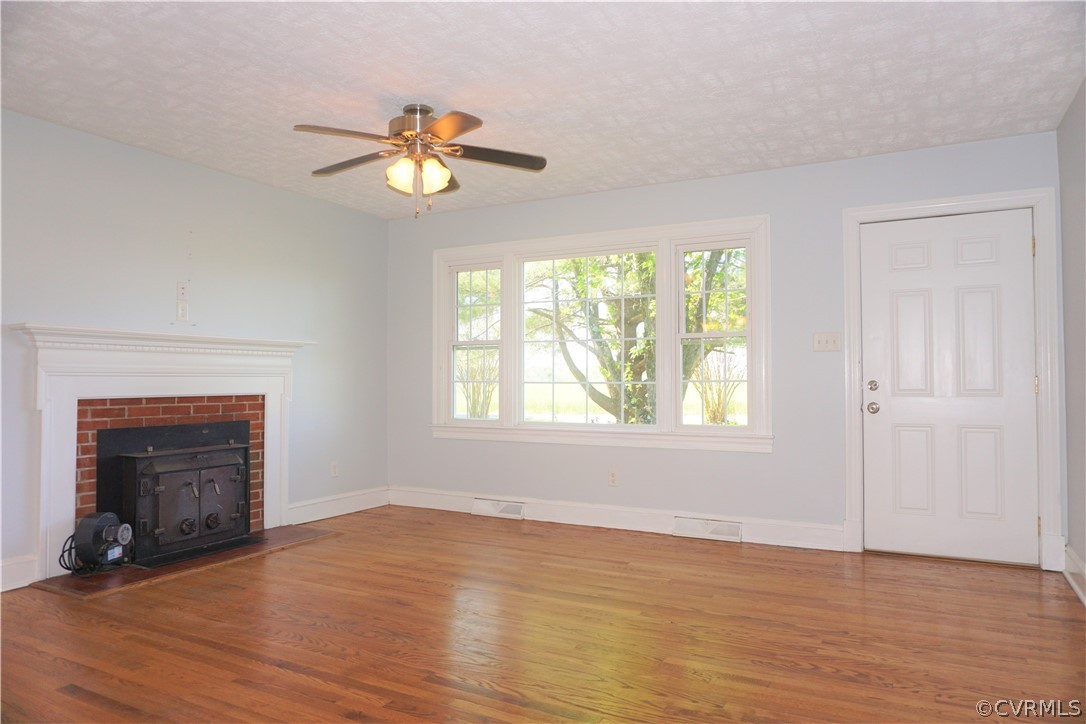 17322 Old Ridge Road Montpelier, VA 23192 - Photo 10 of 50 an empty room with wooden floor fireplace and windows