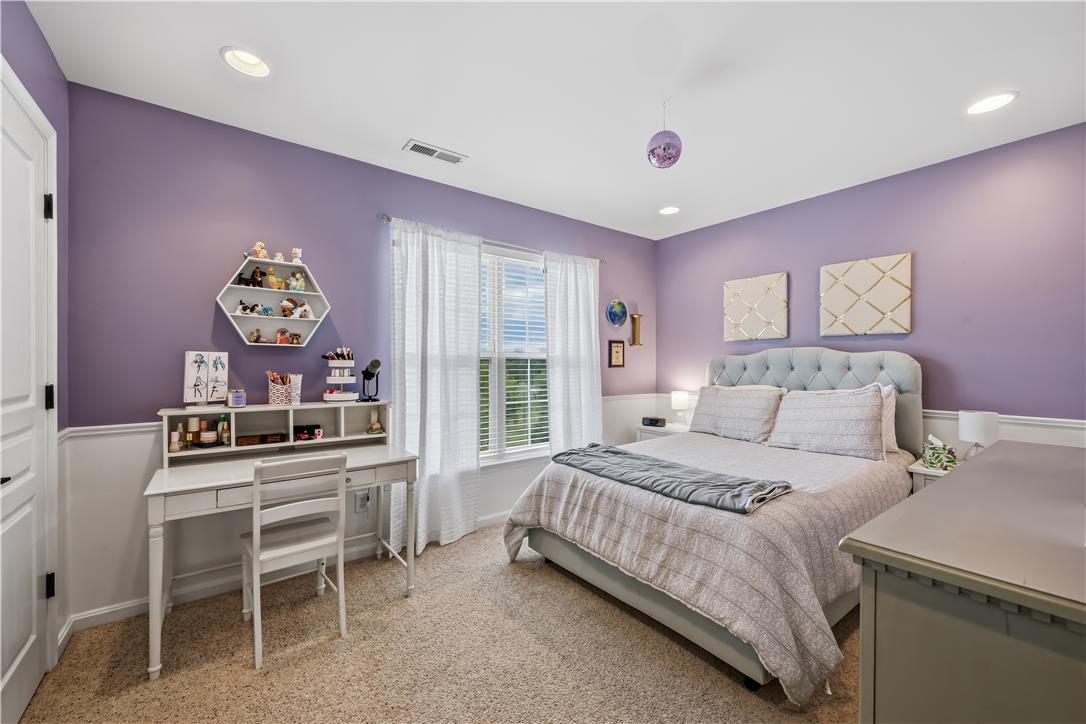 9031 Pathfinder Road Breinigsville, PA 18031 - Photo 40 of 63 Recessed lighting illuminates this inviting bedroom, featuring soft carpet and a serene ambiance.