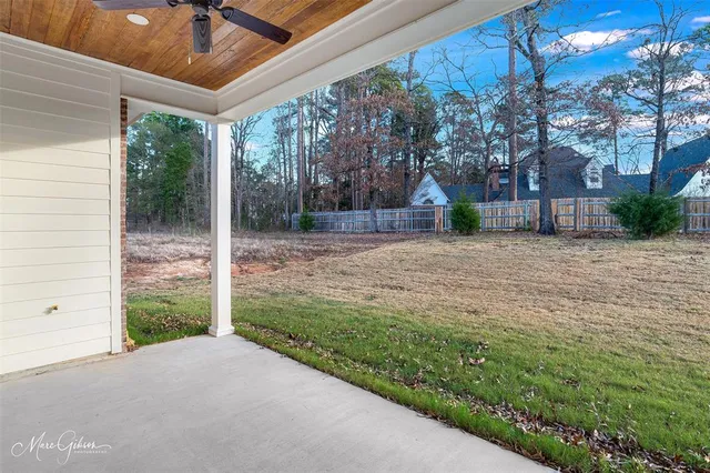 a view of a backyard with large tree