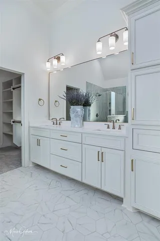 a bathroom with a double vanity sink mirror and a