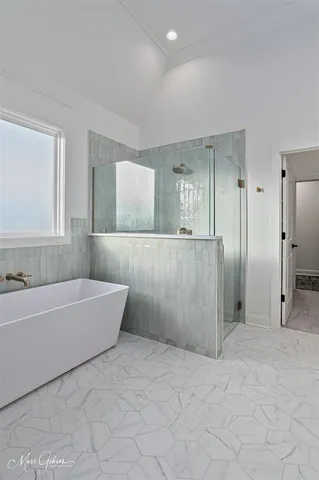 a bathroom with a bathtub and a shower