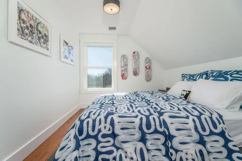 a bedroom with a bed and a night stand