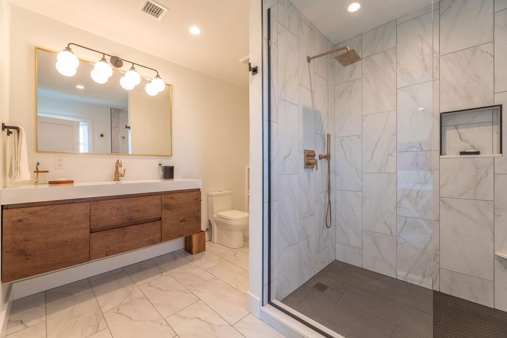 1030 Horseshoe Drive Cutchogue, NY 11935 - Photo 18 of 19 a bathroom with a sink a toilet and shower