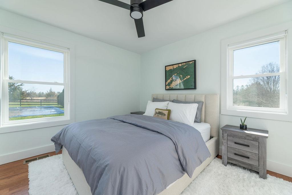 1030 Horseshoe Drive Cutchogue, NY 11935 - Photo 9 of 19 a bedroom with a bed and wooden floor